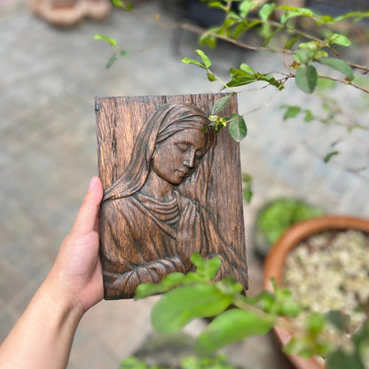 Wood carving of the Virgin Mary in prayer