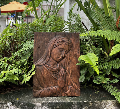 Wood carving of the Virgin Mary in prayer