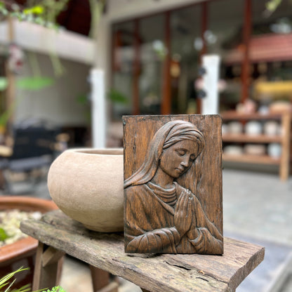 Wood carving of the Virgin Mary in prayer